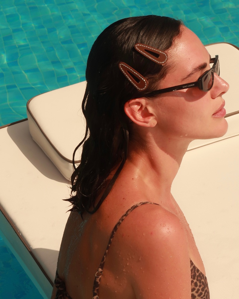 The Hair Club members wearing summer hair accessories by the pool