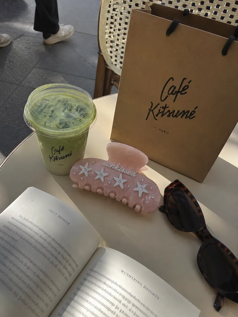 The Hair Club accessories beside matcha and a book