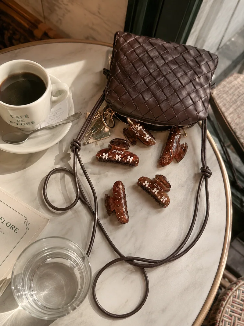 The Hair Club claws beside a handbag at a cafe